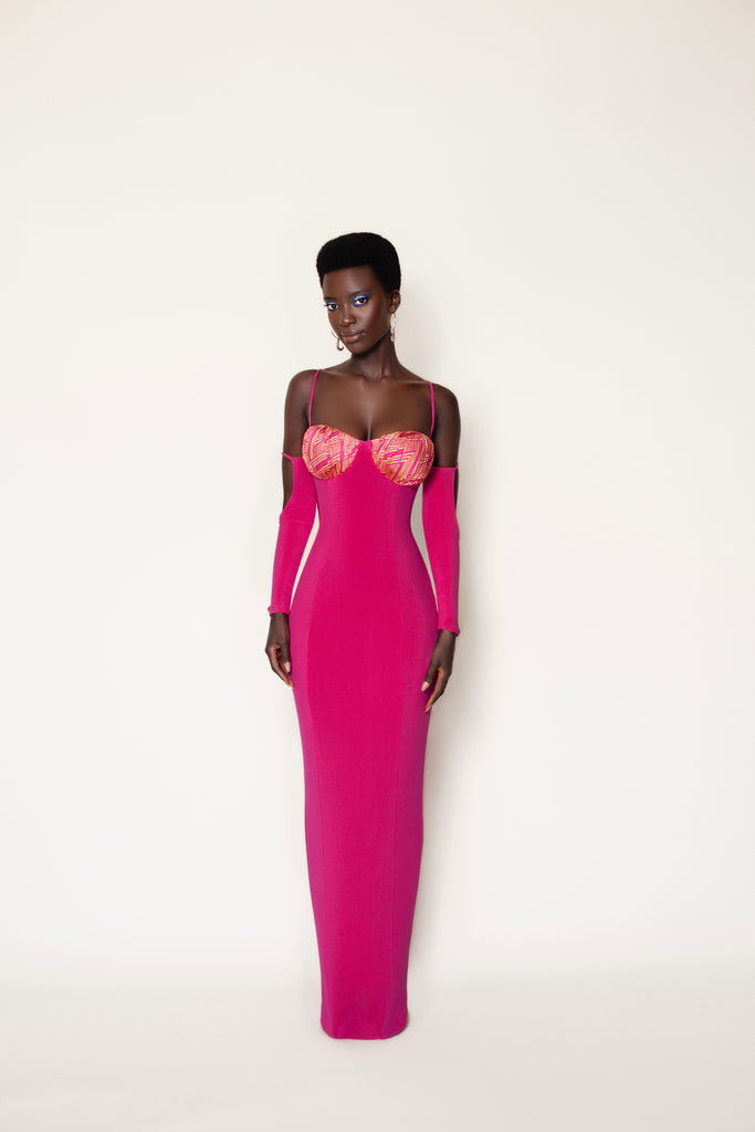 Elegant fuchsia couture gown with intricate floral appliqués, showcasing a sophisticated African fashion design.