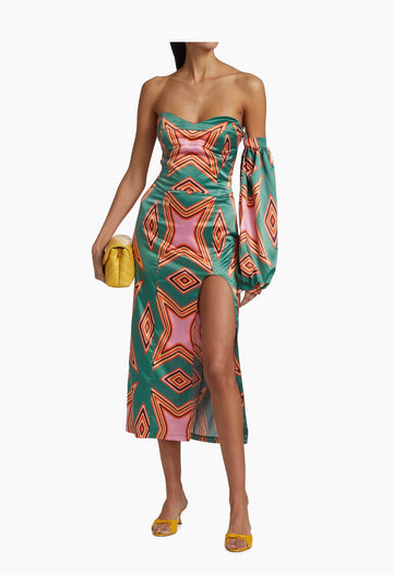 Vibrant geometric-print satin midi-dress with high slit, featuring a strapless neckline and a flowing balloon silhouette.