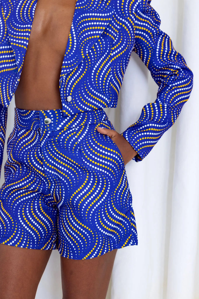 Vibrant African print blazer with abstract swirling patterns in blue and gold tones, showcasing stylish and contemporary fashion design.