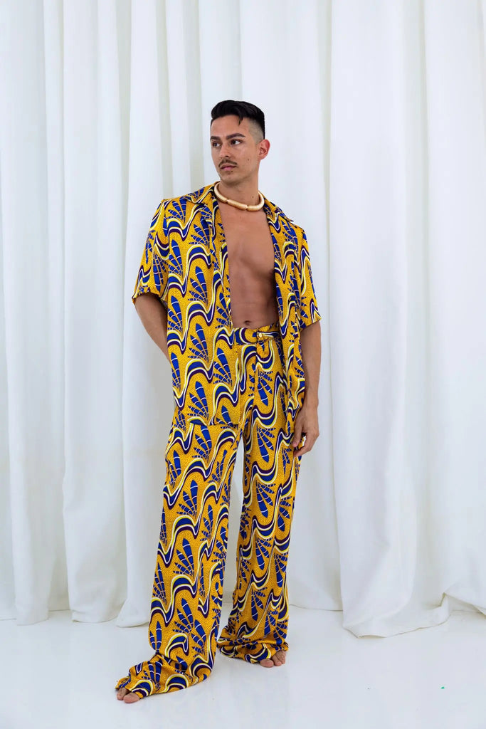 Stylish African print Julian pants for men, featuring a bold, vibrant pattern in warm hues of yellow and blue.