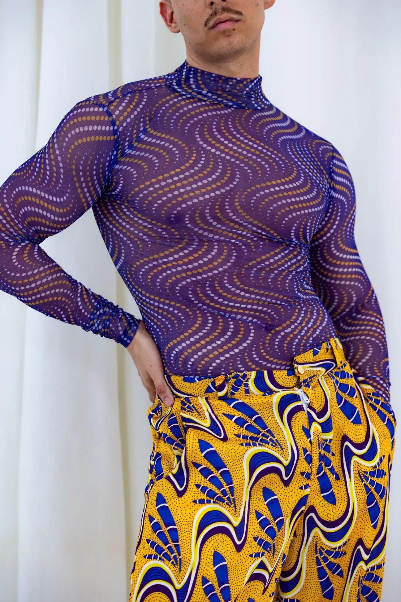 Vibrant African print top with swirling purple and gold pattern for men