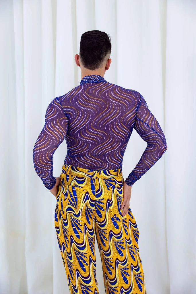 Stylish African print mesh top for men, featuring vibrant purple and yellow abstract wave patterns. The top is designed with a modern, sleek silhouette to showcase the bold prints. This piece from the Claude Kameni collection offers a fashionable take on traditional African textile designs, perfect for making a statement.