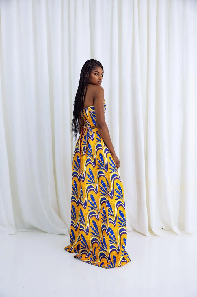 Vibrant yellow and blue African print palazzo pants with a fashionable flared design, showcased by a stylish female model against a plain white background.