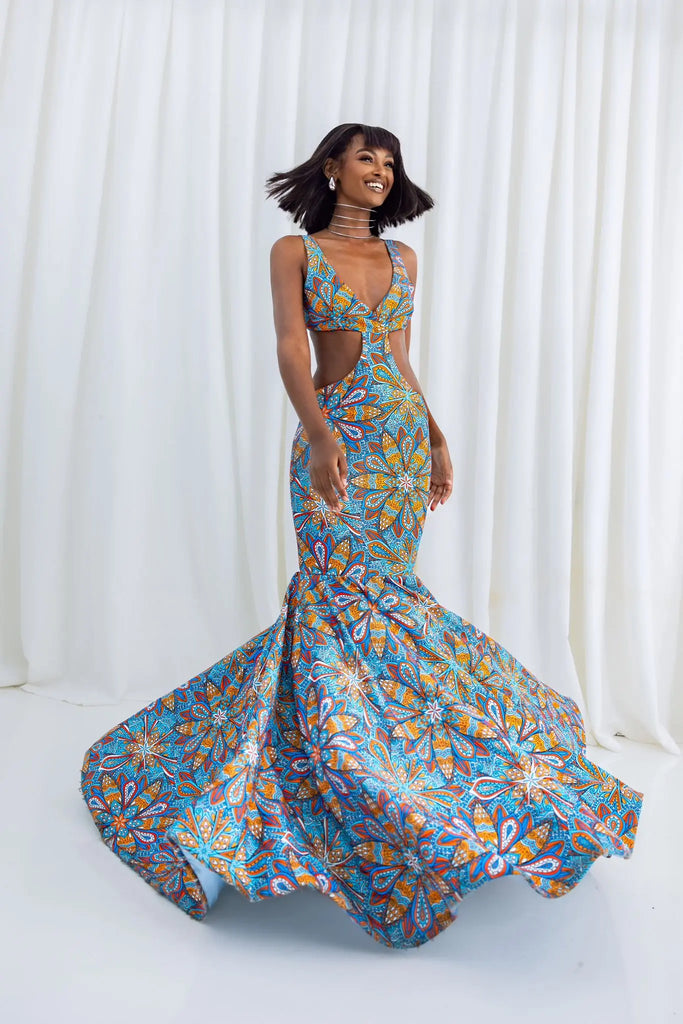 Colorful floral mermaid gown with plunging neckline, tropical floral print, and flowing maxi skirt
