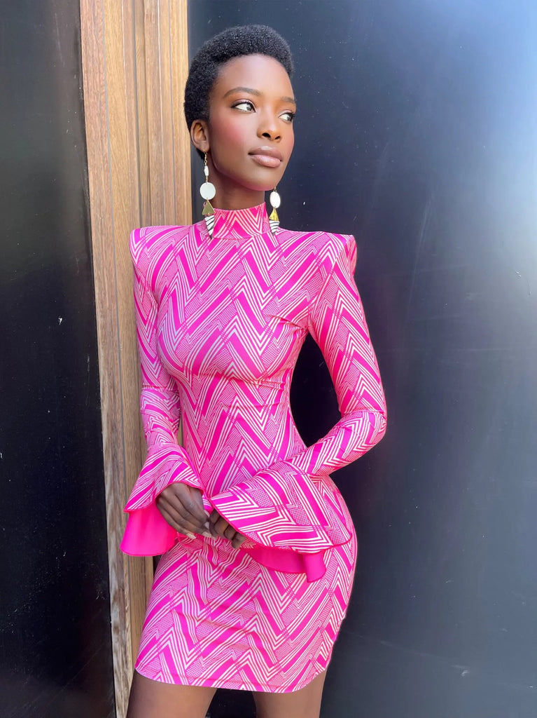 Vibrant African print dress with dynamic zigzag pattern, featuring structured sleeves and a flattering silhouette.