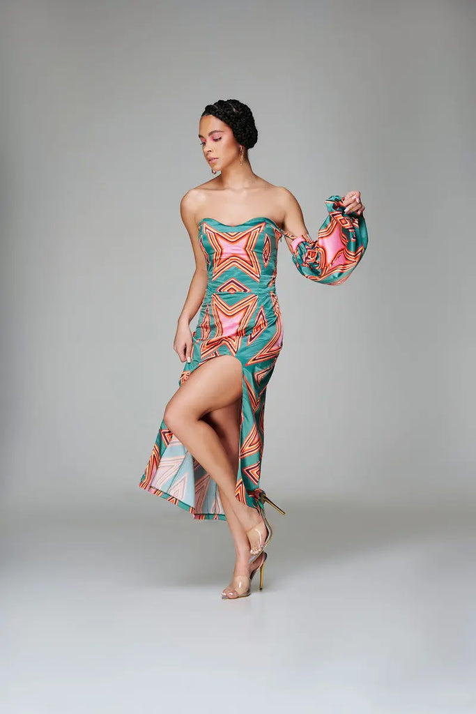 Geometric-print satin midi-dress with vibrant African-inspired patterns, featuring a strapless neckline and a thigh-high slit.
