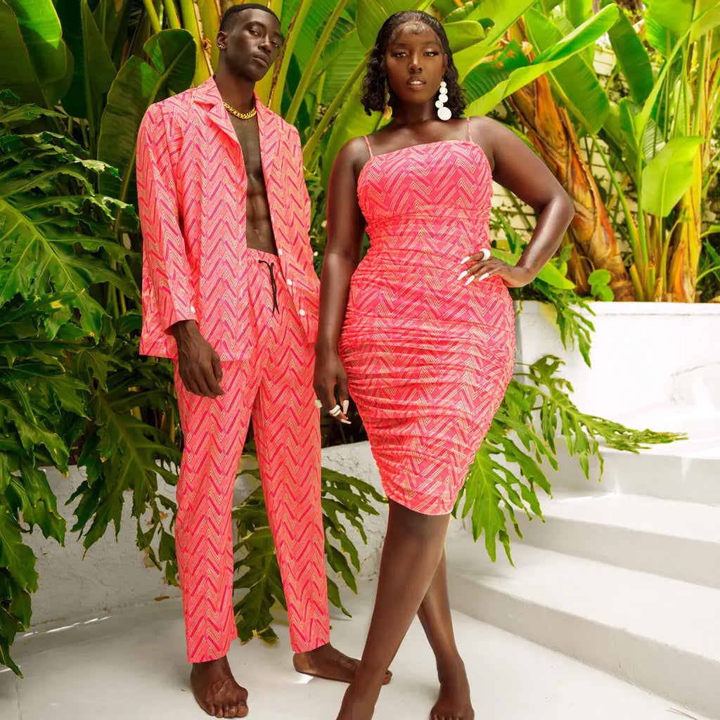 Vibrant African print dress and matching suit in tropical palm leaf setting